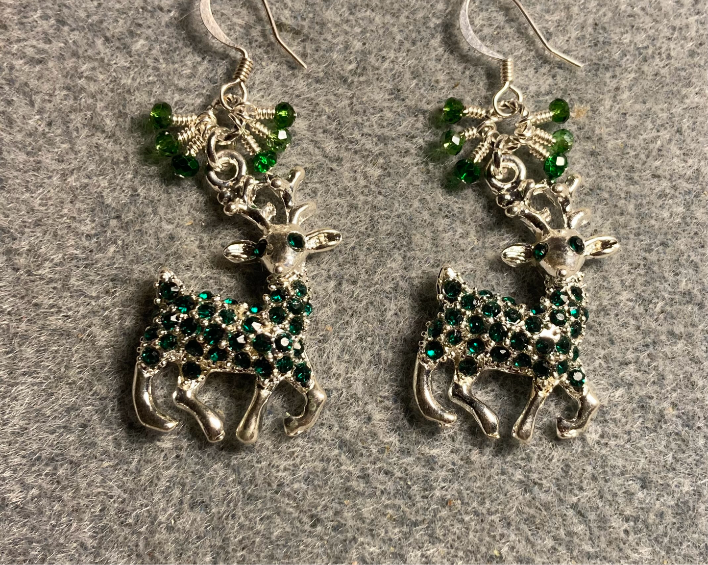 Silver with green rhinestones reindeer charm earrings adorned with tiny dangling green Chinese crystal beads.