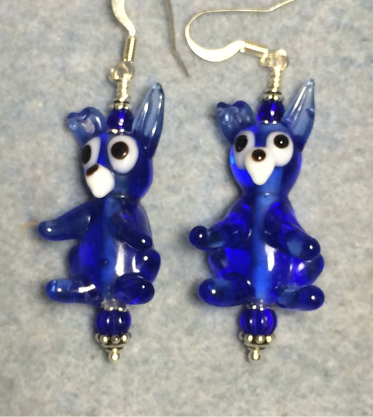 Translucent dark blue kangaroo bead earrings adorned with dark blue Czech glass beads.