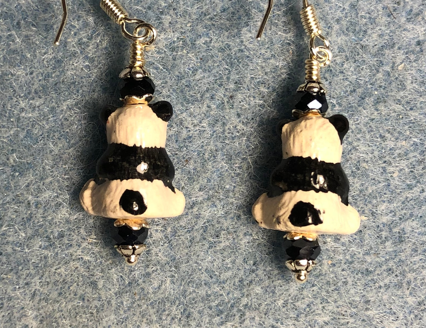 Small white and black ceramic teddy bear bead earrings adorned with black Chinese crystal beads.
