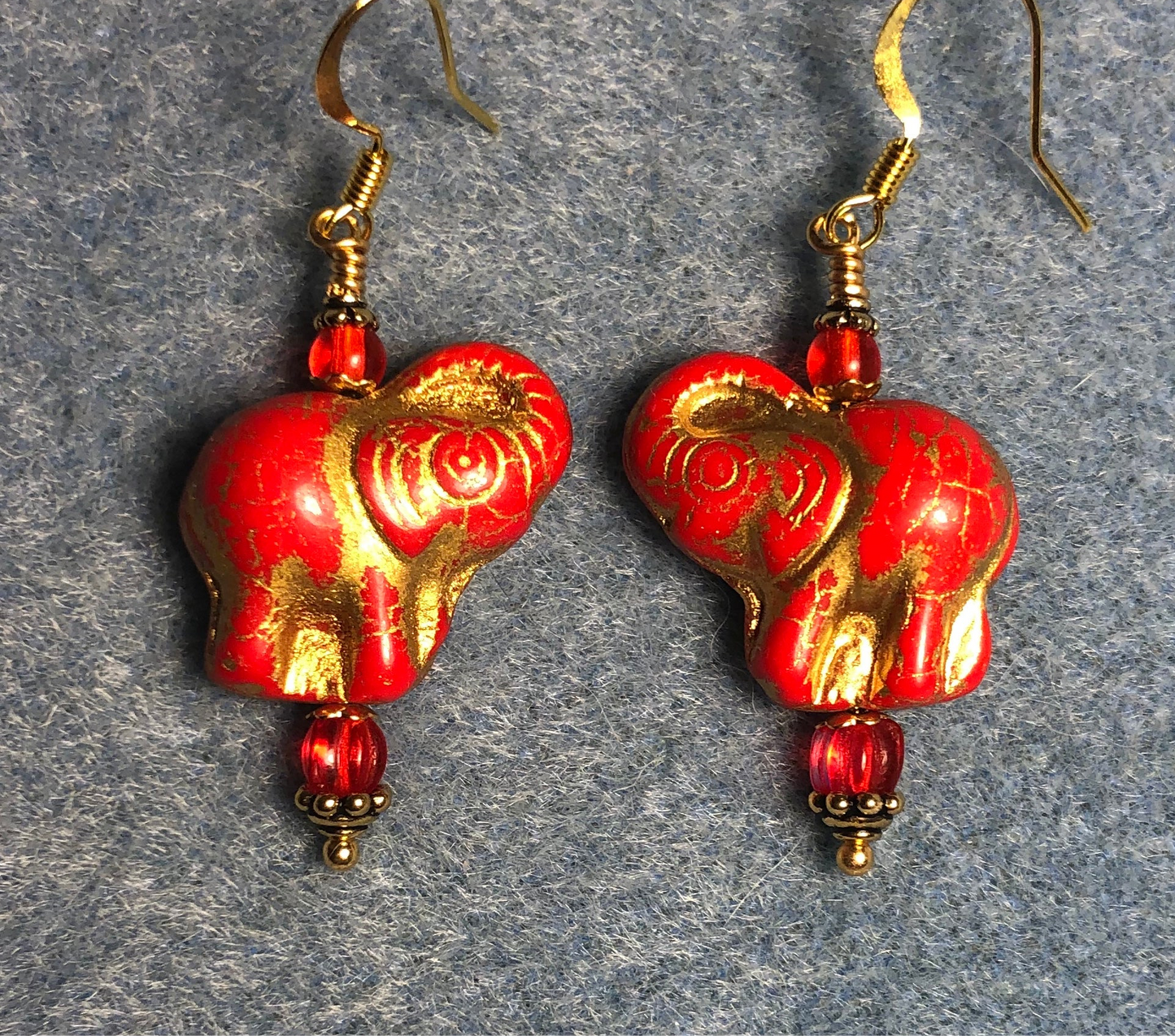 Bright red (with gold inlay) Czech glass elephant bead earrings adorned with red Czech glass beads.