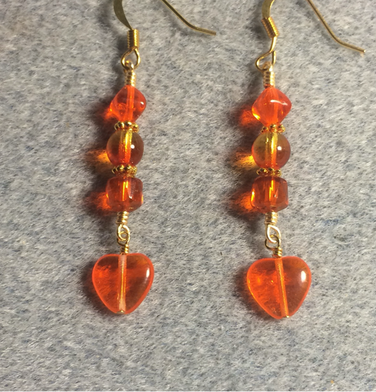 Small bright orange Czech glass heart bead earrings adorned with orange Czech glass beads.