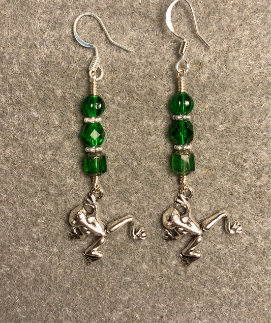 Small silver jumping frog charm earrings adorned with emerald green Czech glass beads.