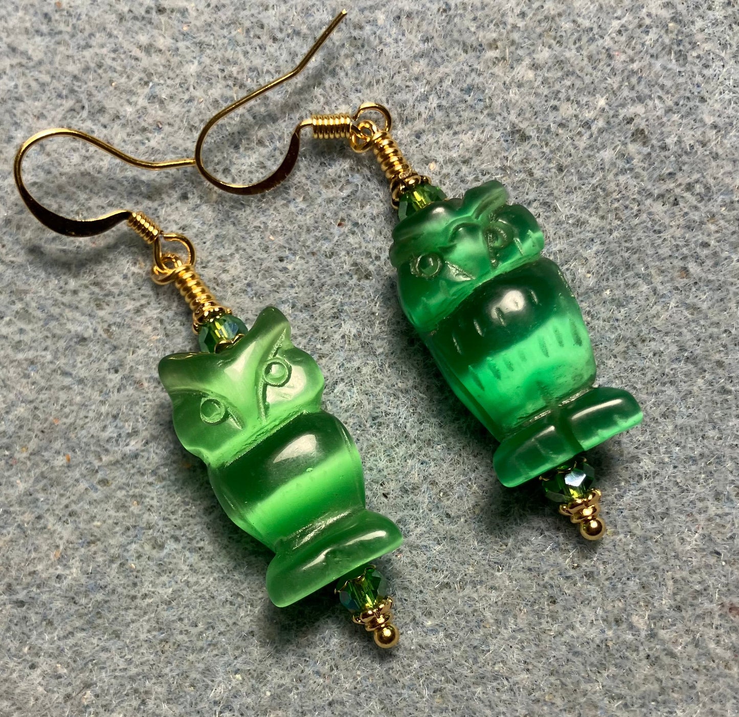 Green fiber optic (cat’s eye) owl bead earrings adorned with green Chinese crystal beads.