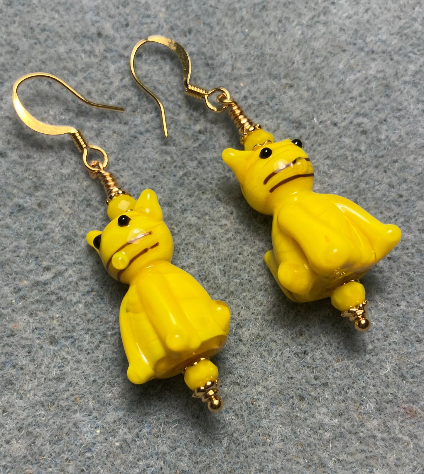 Opaque yellow lamp cat bead earrings adorned with yellow Chinese crystal beads.