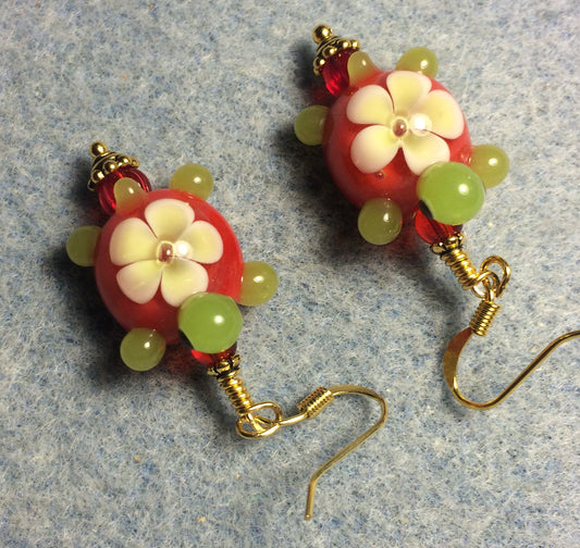 Red and green lamp work turtle bead earrings adorned with red Czech glass beads.