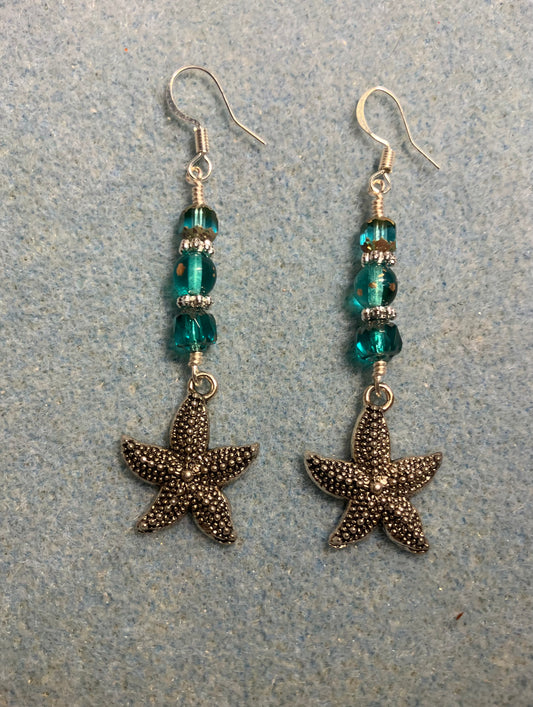 Silver starfish charm earrings adorned with teal Czech glass beads.