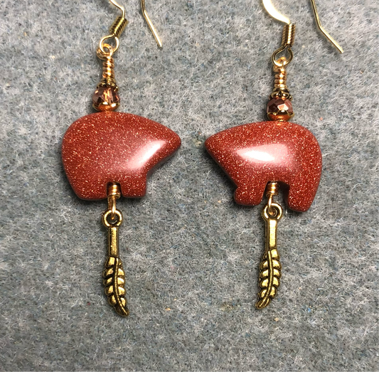 Orange goldstone gemstone Zuni bear fetish bear earrings adorned with orange crystal beads and tiny gold feather charms.
