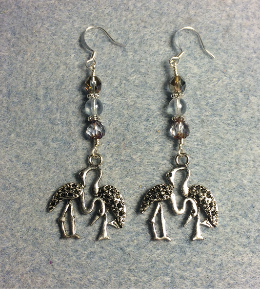 Silver dancing crane charm earrings adorned with light blue Czech glass beads