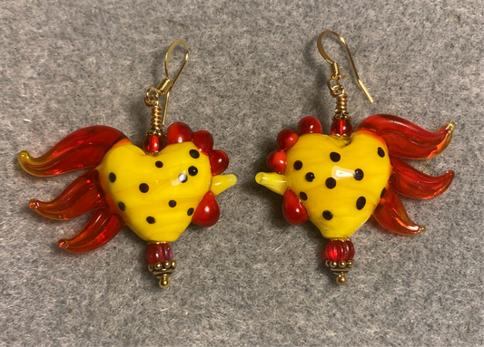 Yellow and red with black spots heart shaped lamp work rooster bead earrings adorned with red Czech glass beads.