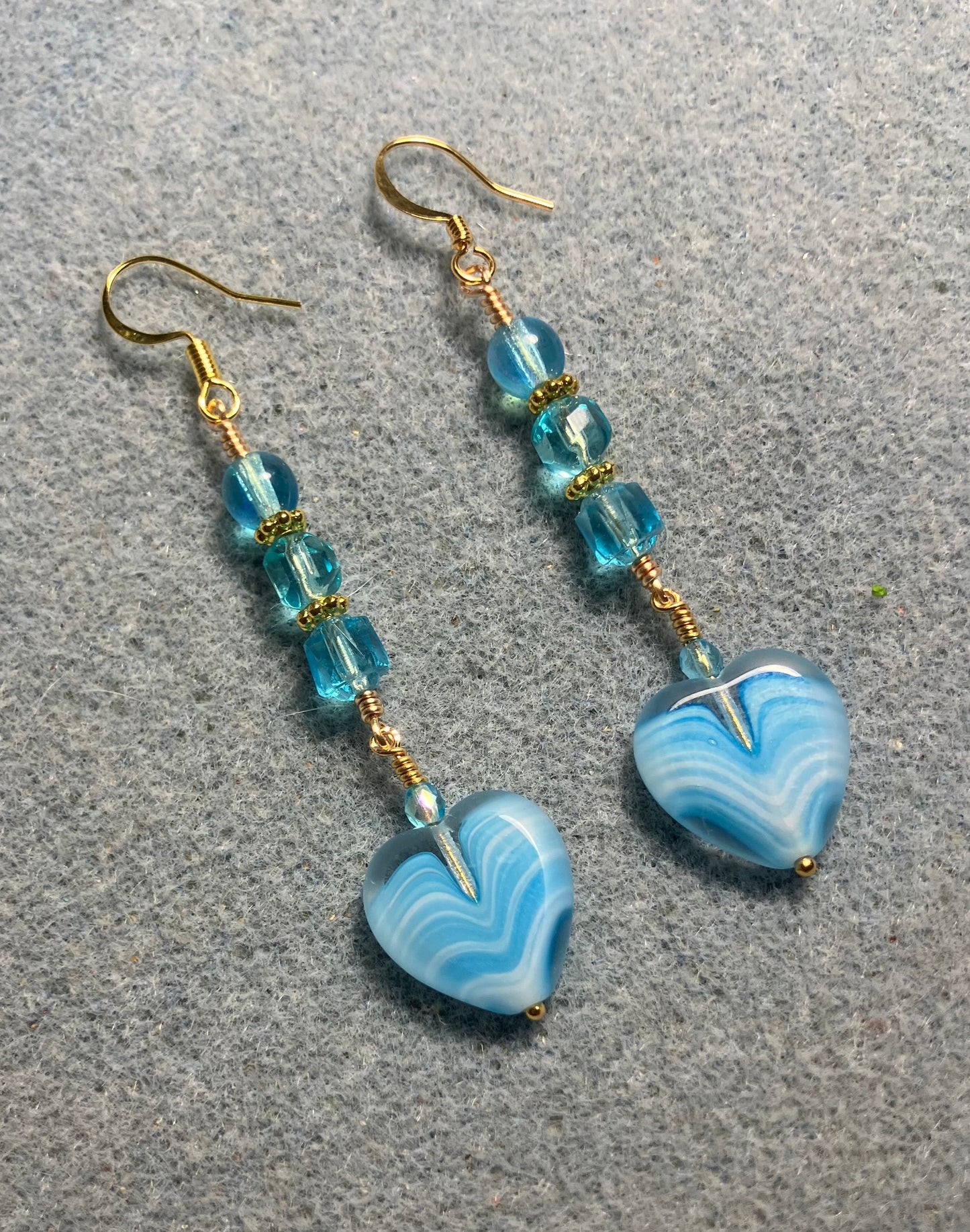 Turquoise Czech glass heart bead earrings adorned with turquoise Czech glass beads.