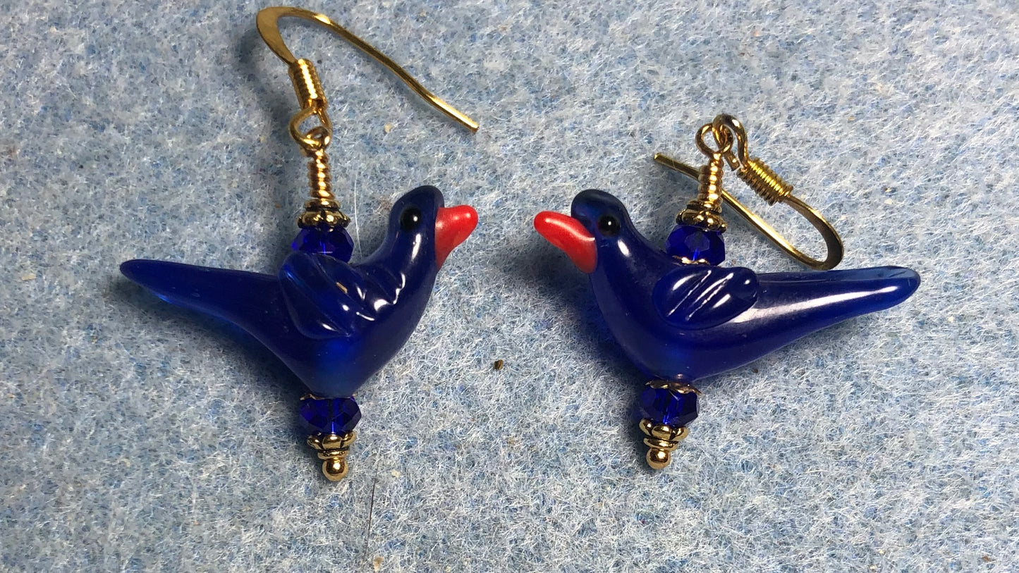 Opaque dark blue lamp work songbird bead earrings adorned with dark blue Chinese crystal beads.