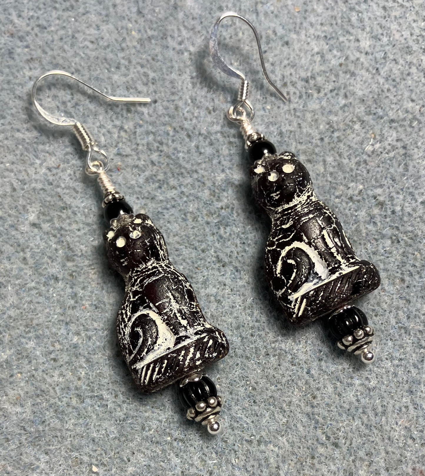 Black (with white inlay) fancy Czech glass cat bead earrings adorned with black Czech glass beads.