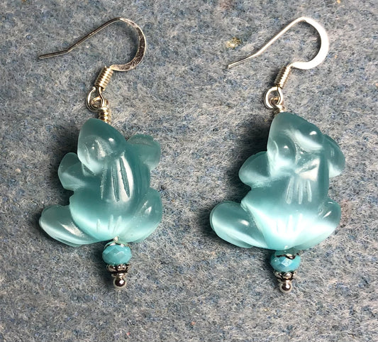 Turquoise fiber optic (cat’s eye) frog bead earrings adorned with turquoise Chinese crystal beads.