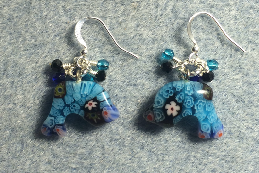 Turquoise millefiori lamp work dolphin bead earrings adorned with tiny dangling turquoise, black, and blue Czech glass beads.