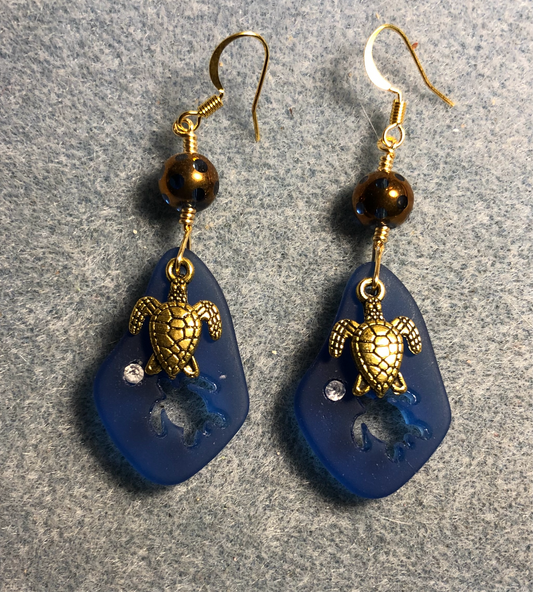 Dark blue sea glass sea turtle pendant bead earrings adorned with gold sea turtle charms and dark blue and gold Czech glass beads.