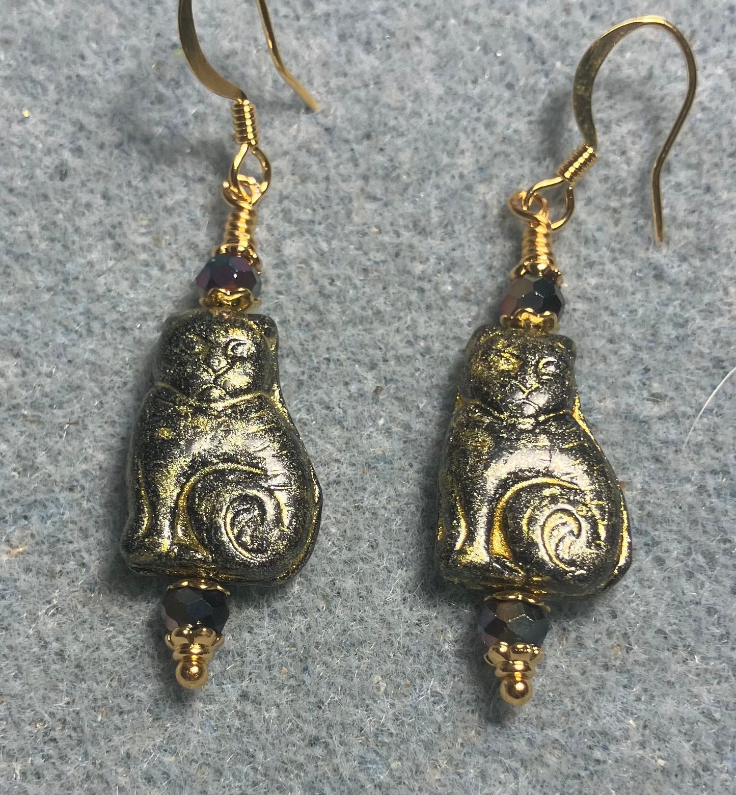 Medium black (with gold wash) Czech glass cat bead earrings adorned with black Chinese crystal beads.