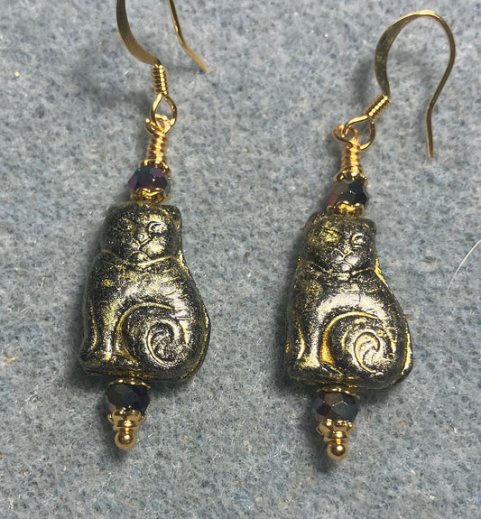 Medium black (with gold wash) Czech glass cat bead earrings adorned with black Chinese crystal beads.