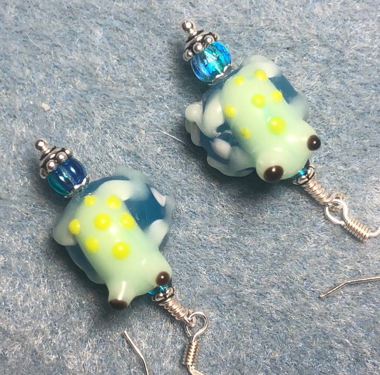 Turquoise, white, and light green lamp work frog bead earrings adorned with turquoise Czech glass beads.