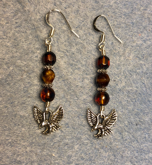 Silver hawk charm earrings adorned with brown Czech glass beads