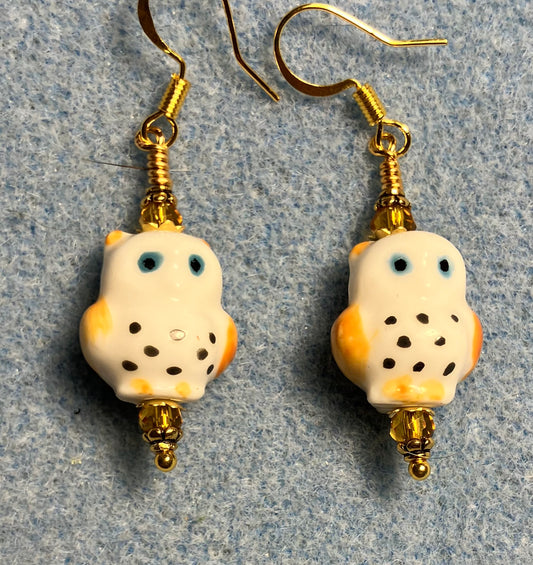 Amber, white, and blue ceramic spotted owl bead earrings adorned with amber Chinese crystal beads.