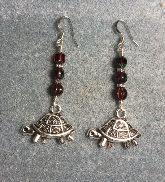 Silver tortoise charm earrings adorned with dark red Czech glass beads