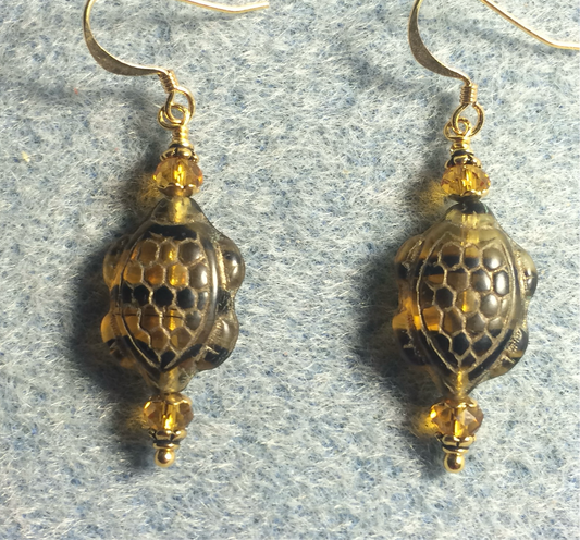 Amber and black Czech glass striped turtle bead earrings adorned with amber Chinese crystal beads.