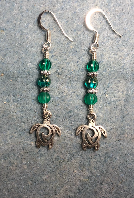 Silver sea turtle charm earrings adorned with teal Czech glass melon beads