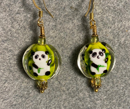 Green, black, and white lamp work panda bear bead earrings adorned with olive green Czech glass beads.