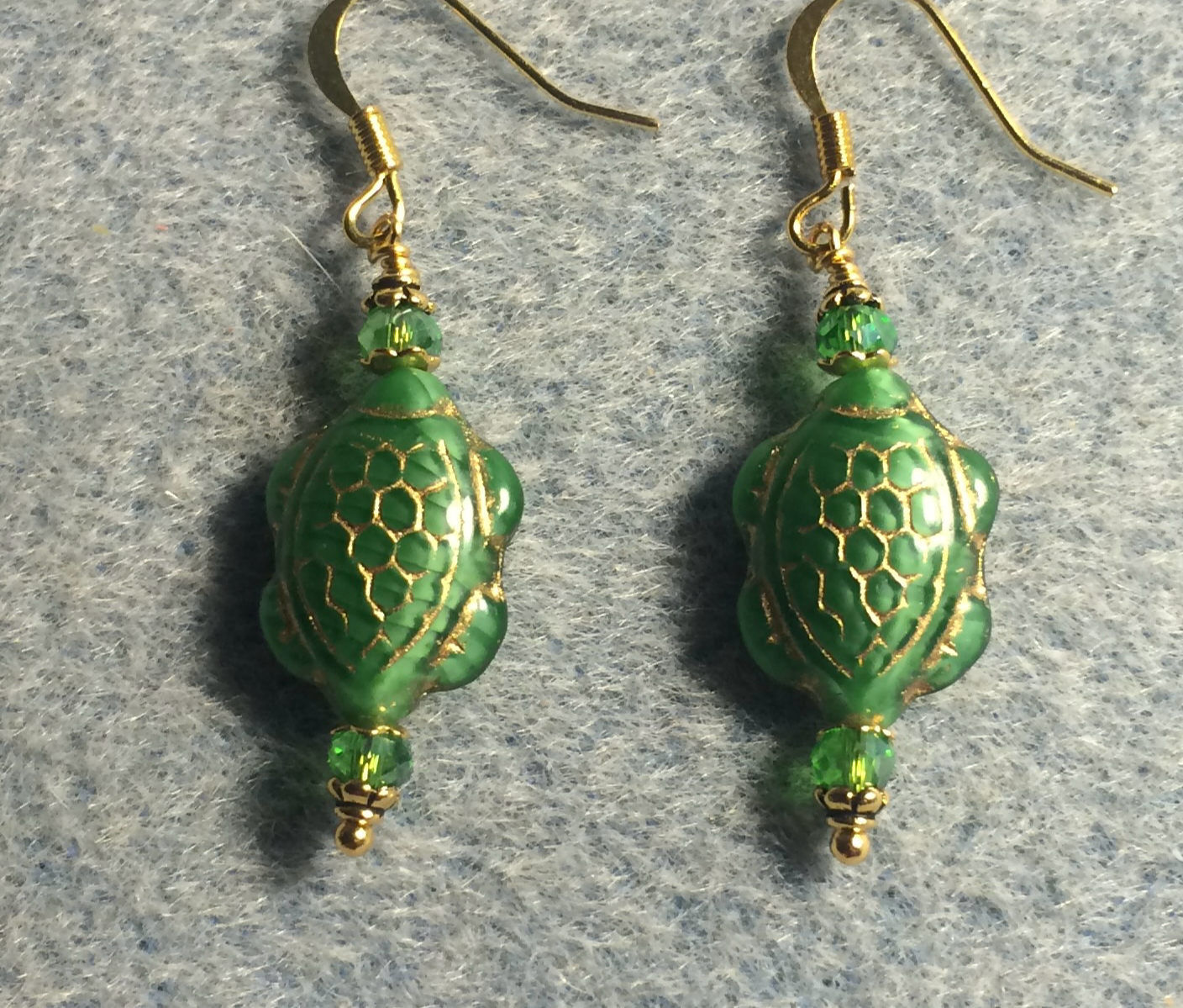 Kelly green (with gold inlay) Czech glass turtle bead earrings adorned with kelly green Chinese crystal beads.