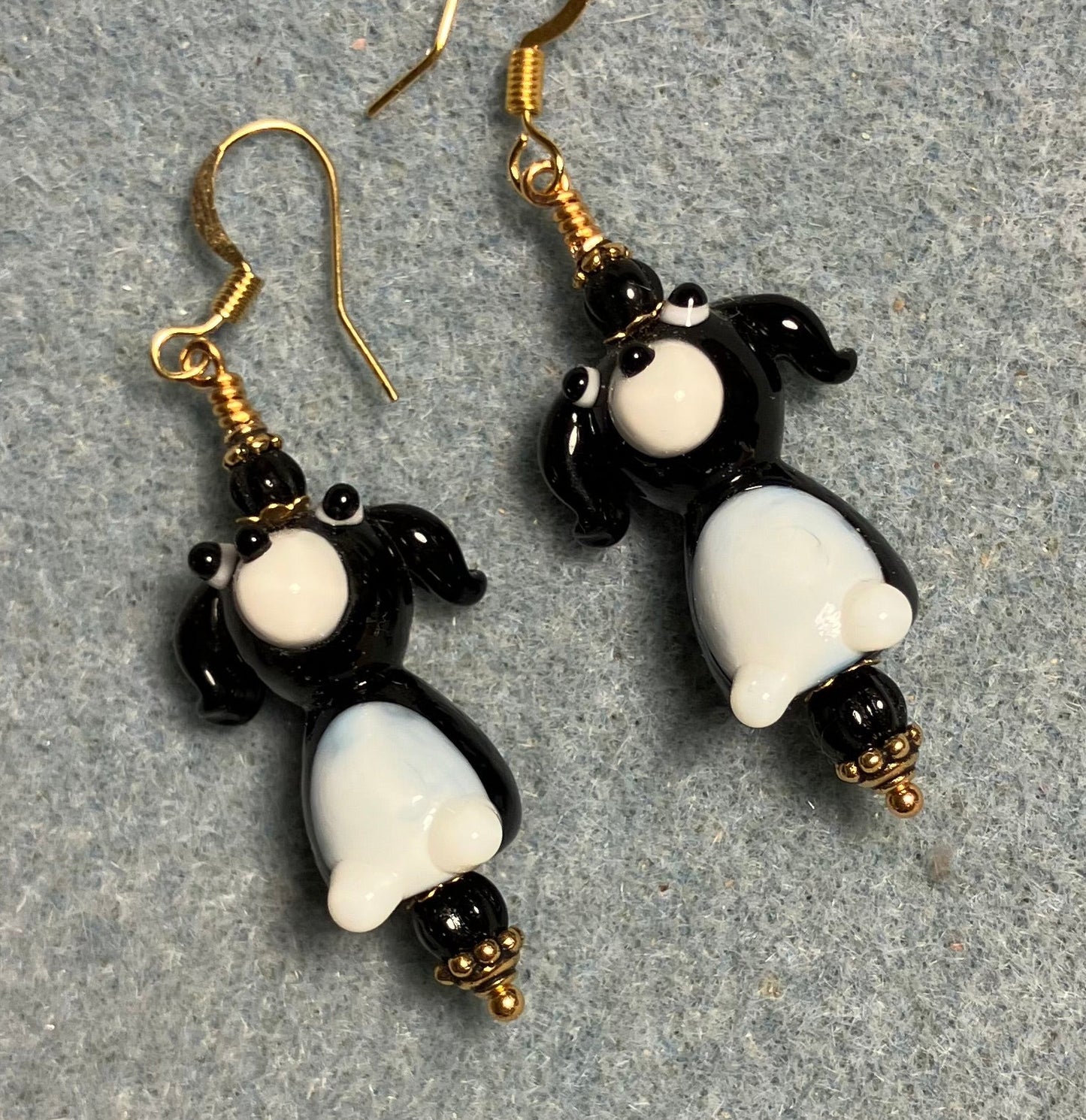 White and black lamp work puppy dog bead earrings adorned with black Czech glass beads.