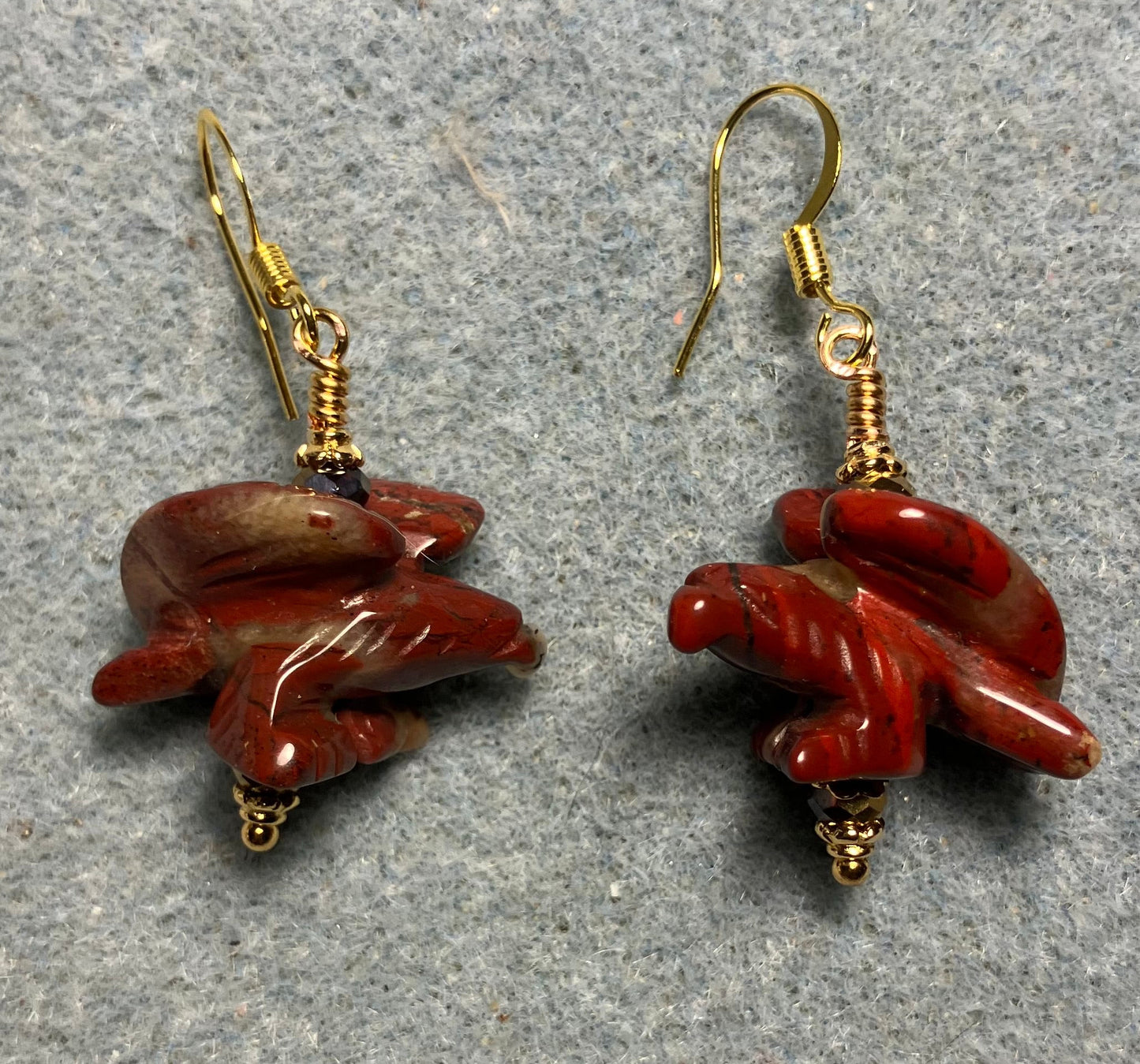 Large red poppy jasper gemstone flying eagle bead earrings adorned with dark red Chinese crystal beads.