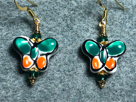 Teal and orange ceramic butterfly bead earrings adorned with teal Chinese crystal beads.