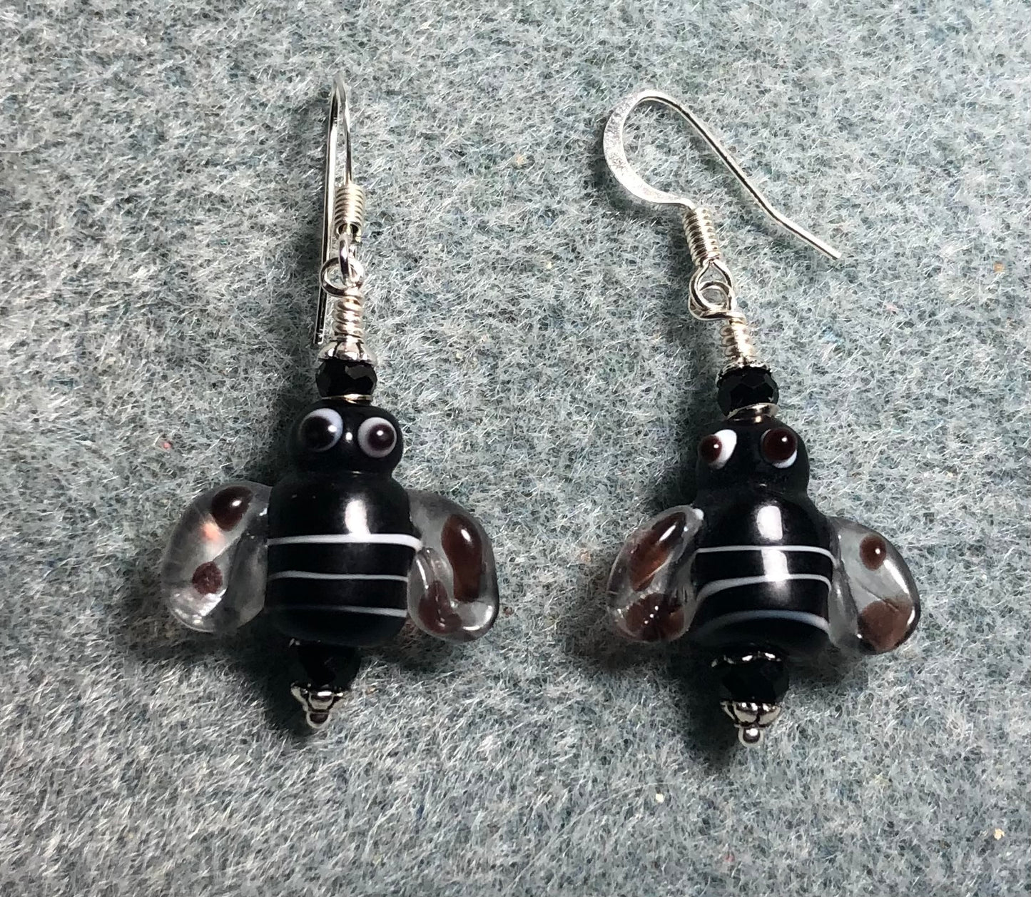 Black and white lamp work striped honeybee bead earrings adorned with black Chinese crystal beads.