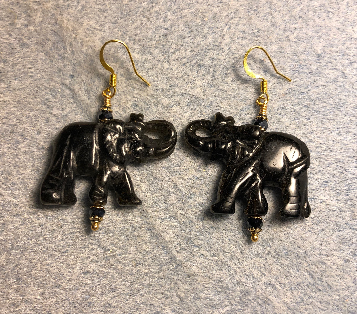 Large black onyx gemstone elephant bead earrings adorned with black Chinese crystal beads.