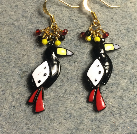 Black, white, yellow, and red enamel toucan charm earrings adorned with tiny dangling black, yellow, and red Chinese crystal beads.