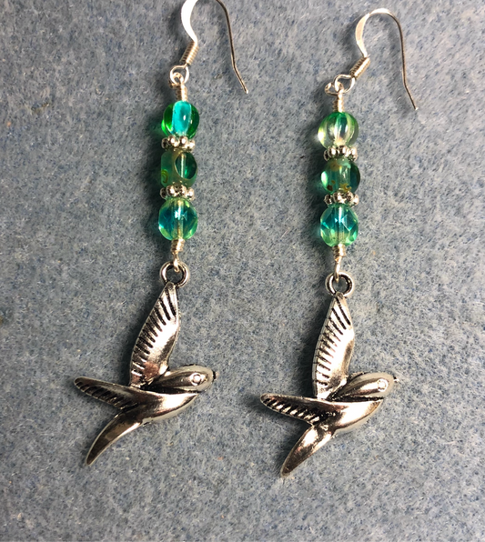 Silver flying bird charm earrings adorned with blue green Czech glass beads