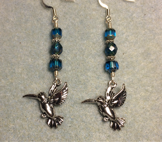 Silver hummingbird charm earrings adorned with dark turquoise Czech glass beads