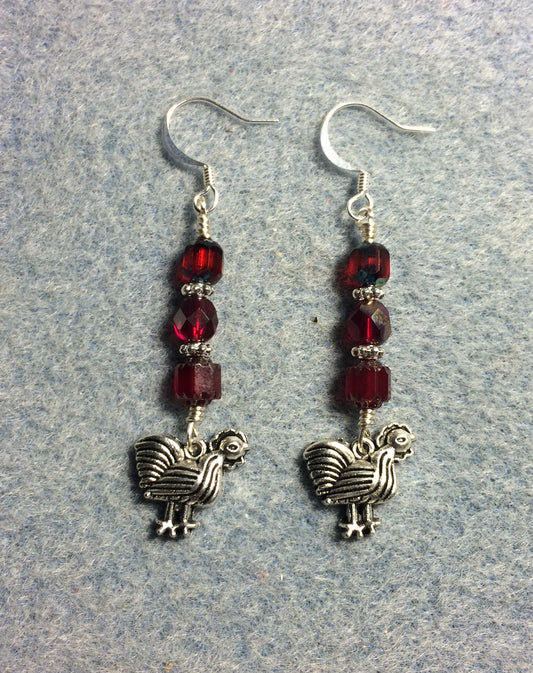 Silver chicken charm earrings adorned with dark red Czech glass beads
