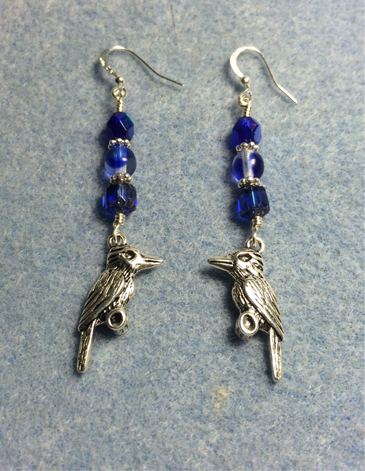 Silver kookaburra charm earrings adorned with bright blue Czech glass lentil beads.