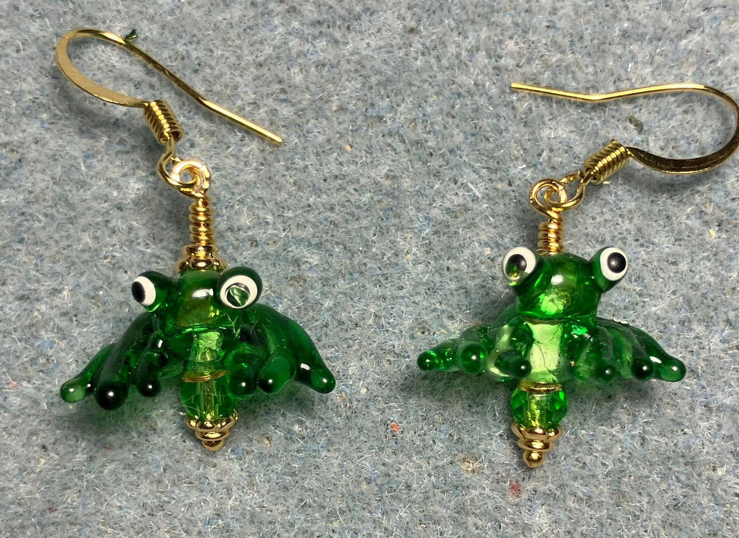 Tiny shiny kelly green lamp work frog bead earrings adorned with tiny kelly green Chinese crystal beads.
