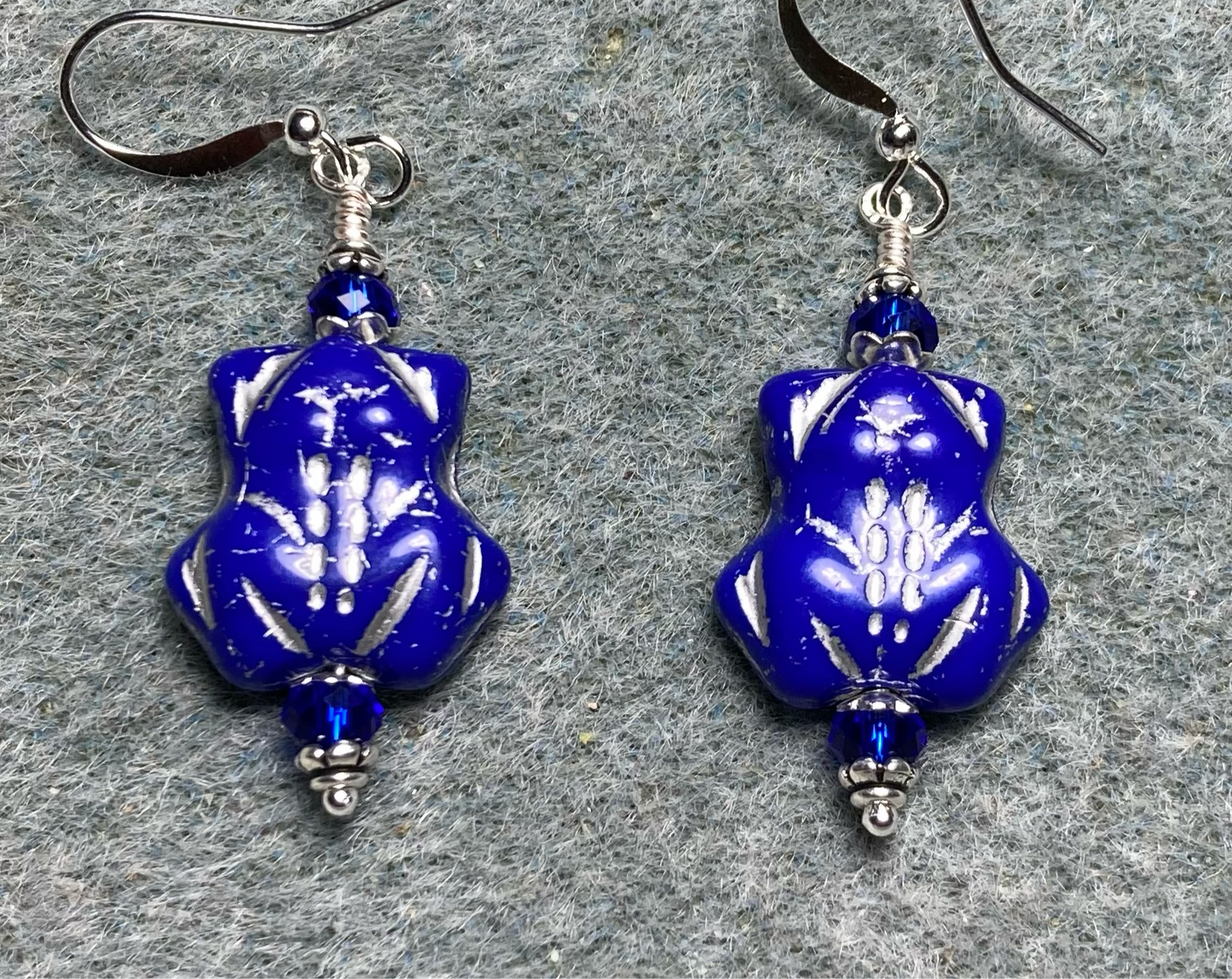 Blue (with silver inlay) Czech glass turtle bead earrings adorned with blue Chinese crystal beads.