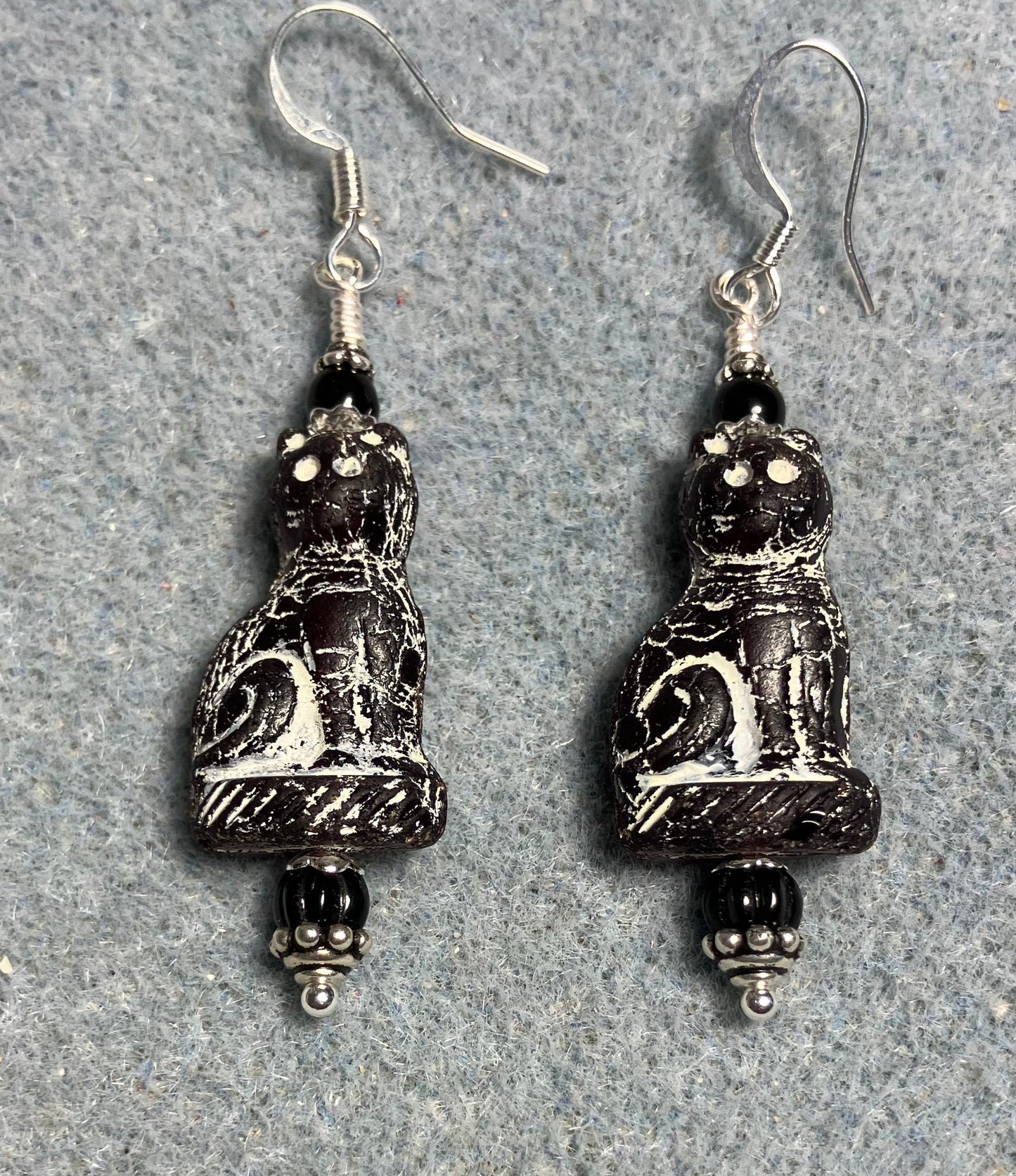 Black (with white inlay) fancy Czech glass cat bead earrings adorned with black Czech glass beads.