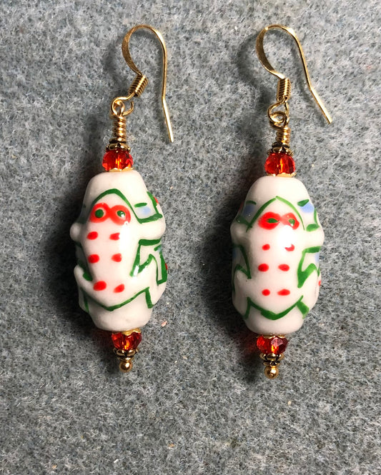 White, green, and orange ceramic frog bead earrings adorned with orange Chinese crystal beads.