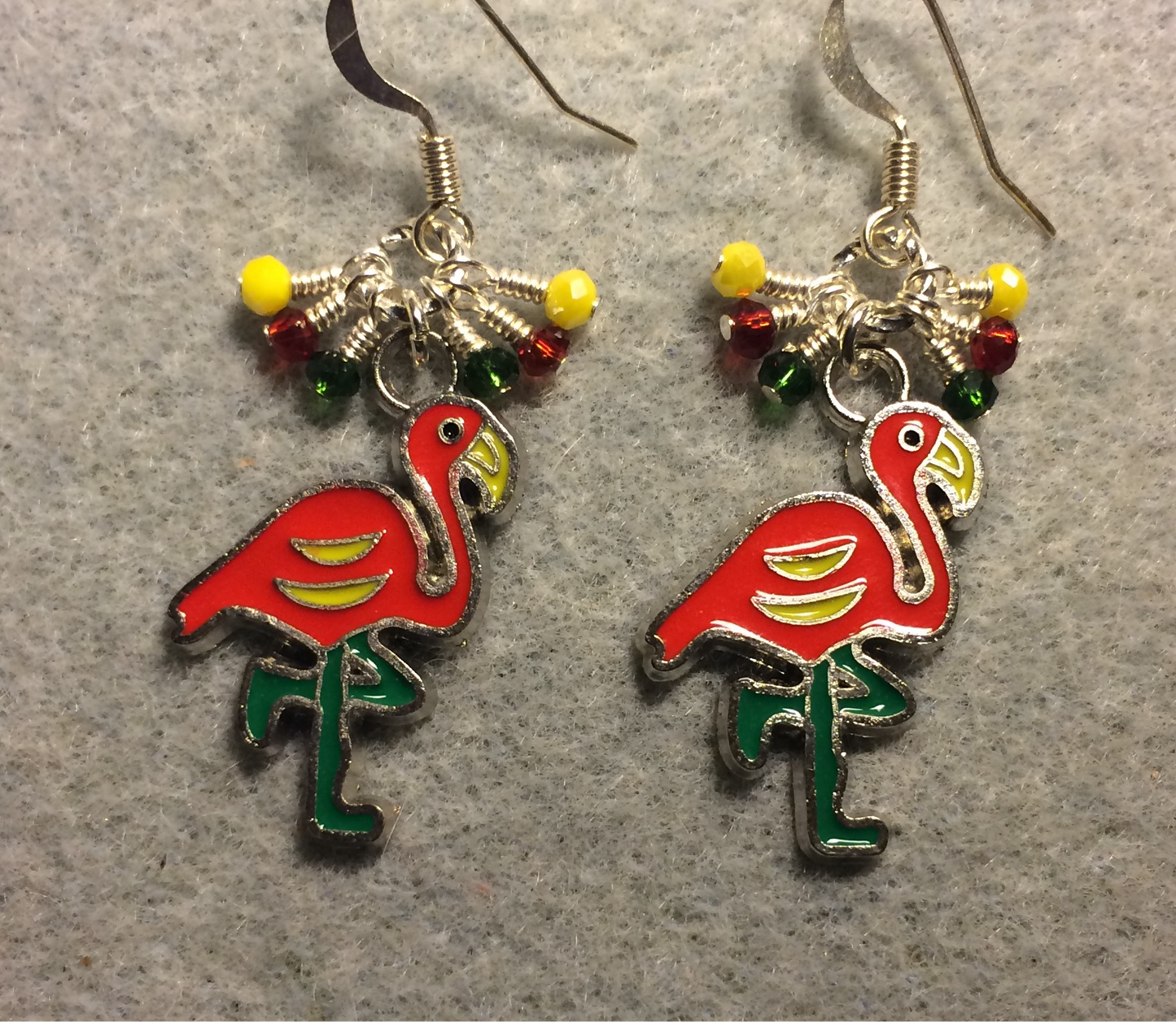 Red and green enamel flamingo charm earrings adorned with tiny dangling red, yellow, and green Chinese crystal beads.