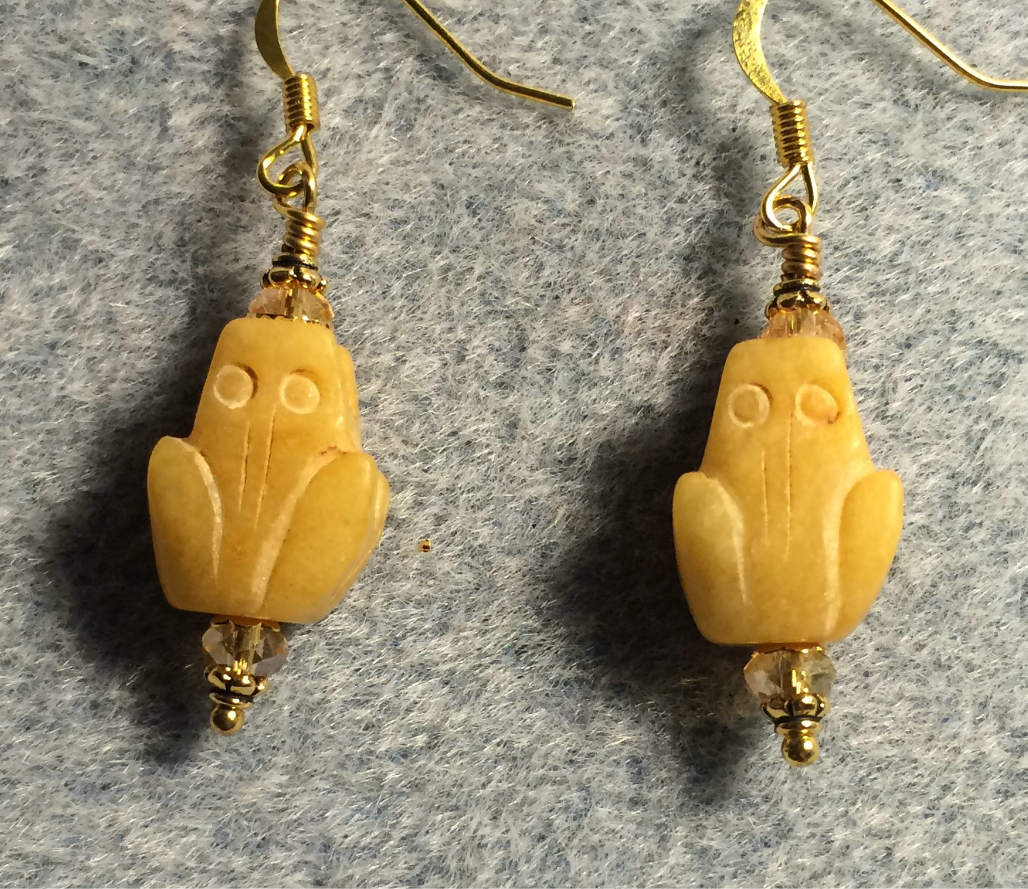 Carved yellow jade gemstone frog bead earrings adorned with amber Chinese crystal beads.