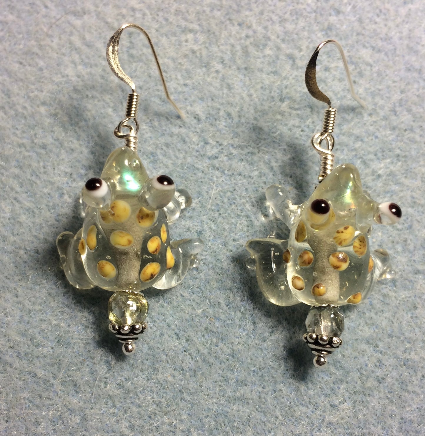 Clear lamp work spotted frog bead earrings adorned with clear Czech glass beads.