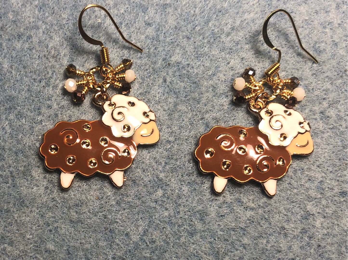 Brown, gold, and white enamel sheep charm earrings adorned with tiny dangling brown and white Chinese crystal beads.