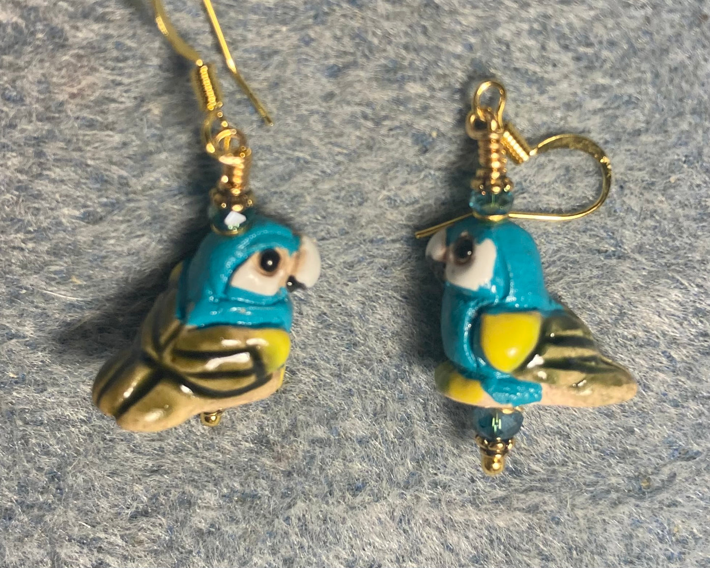 Small turquoise and yellow ceramic parrot bead earrings adorned with turquoise Chinese crystal beads.