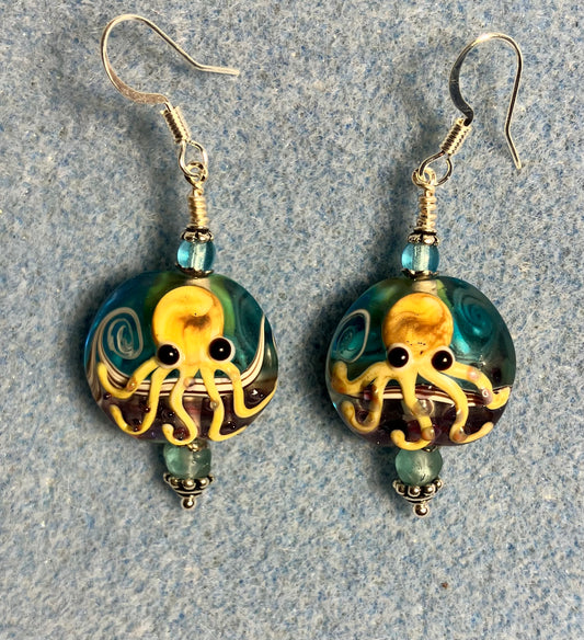 Light aqua and tan lamp work octopus bead earrings adorned with light aqua Chinese crystal beads.