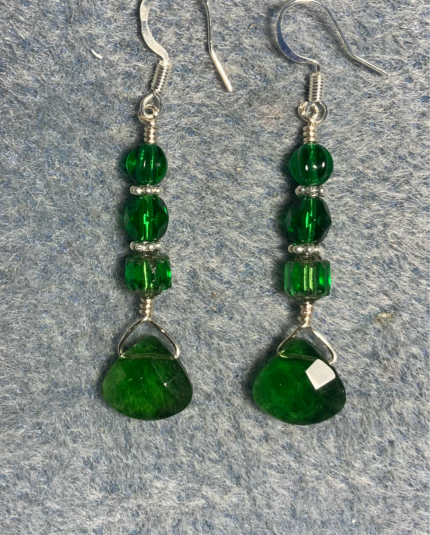 Emerald green Czech glass briolette bead earrings adorned with emerald green Czech glass beads.